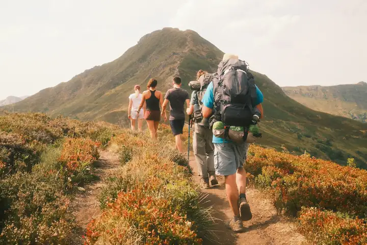 Friends hiking together on a mountain trail