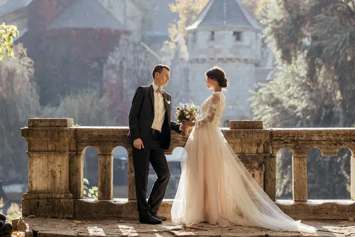 A bride and groom on a castle terrace